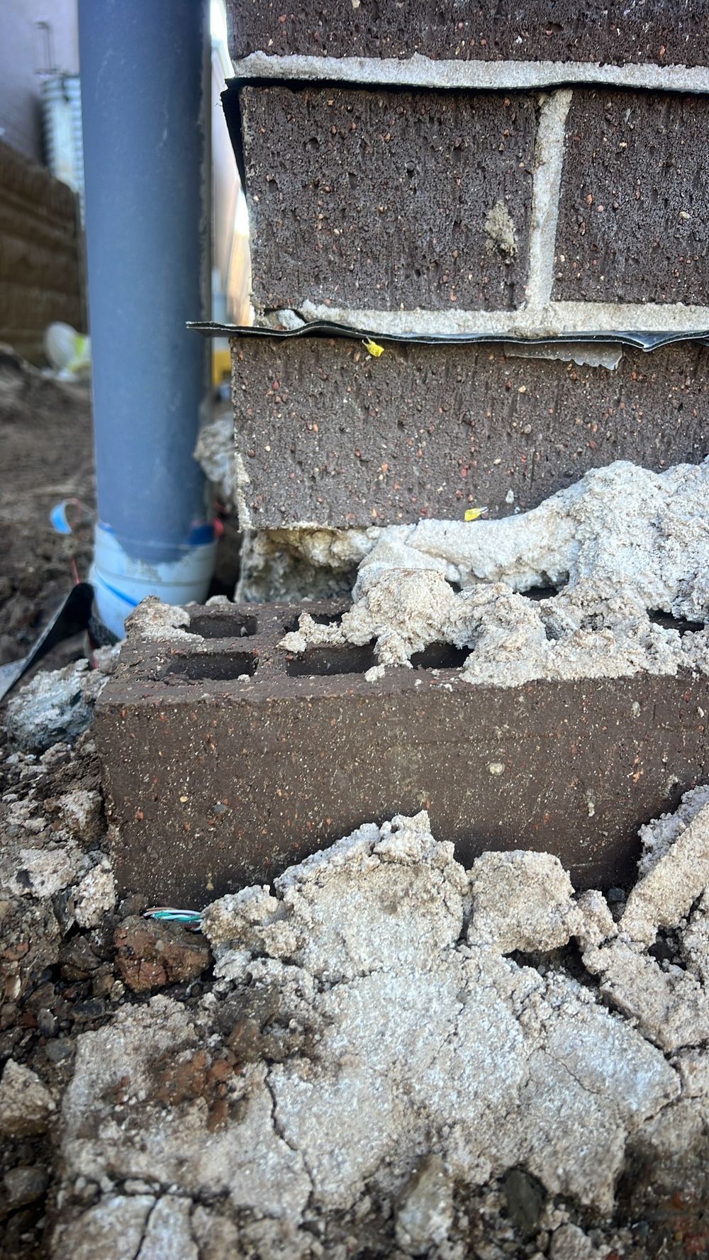 Brickwork hanging over the edge of the slab
